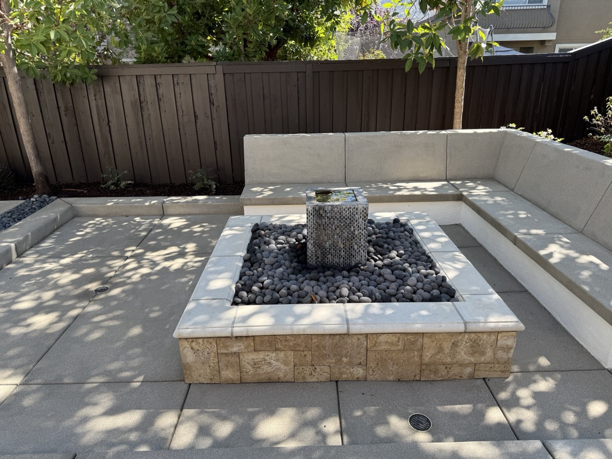 Clean patio with stone fountain after pressure washing